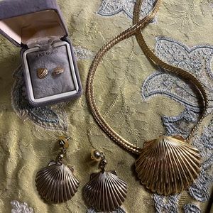 Gold shell shaped necklace with two set of matching earrings.